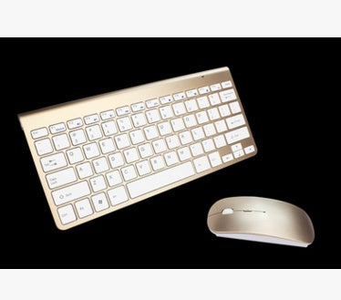 rose gold wireless compact keyboard and slim mini mouse on black background