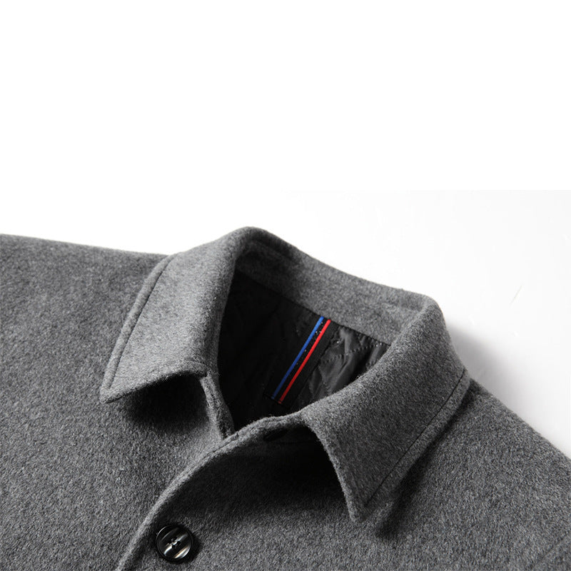Close-up of men's gray wool mid-length coat with black buttons and quilted inner lining