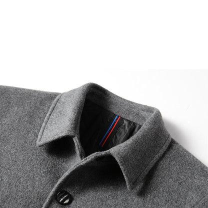 Close-up of men's gray wool mid-length coat with black buttons and quilted inner lining