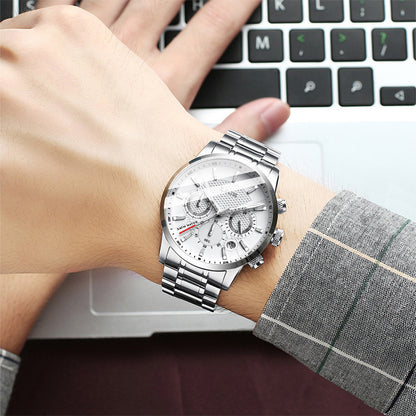 men's silver stainless steel sport quartz watch with white dial on wrist typing on laptop