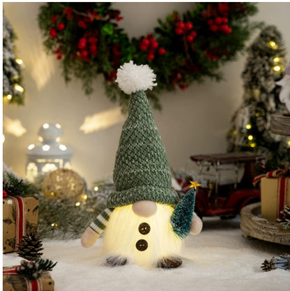 Christmas gnome decoration with green knit hat and miniature tree, surrounded by festive wreath and lights