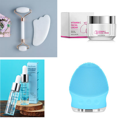 Skincare tools and products including jade roller, gua sha, vitamin C cream, hyaluronic acid serum, and blue facial cleansing brush