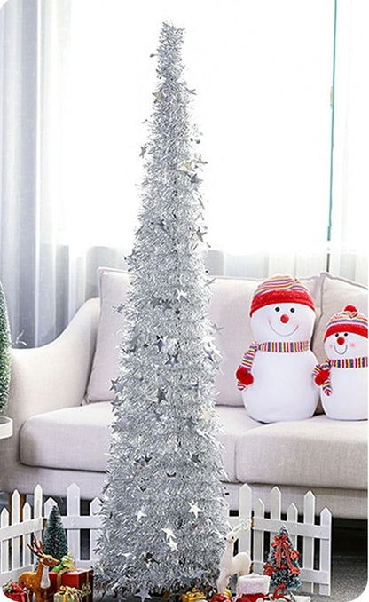 Tall slim silver sequin Christmas tree with star decorations in living room with snowman plush and holiday décor