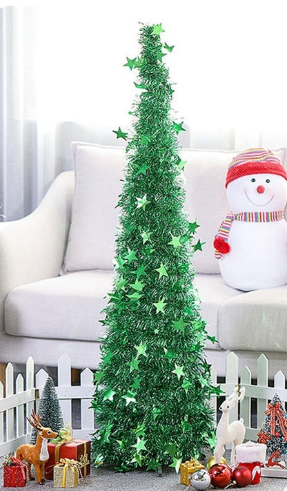 Green star-decorated folding Christmas tree with gifts and festive figurines by white picket fence