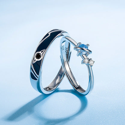925 silver couple rings with unisex planet design and blue gemstone on light blue background