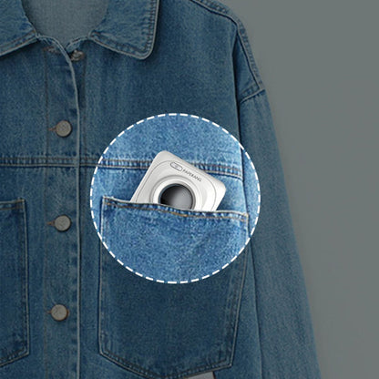 Compact white portable mini thermal photo printer in denim jacket pocket with blue background