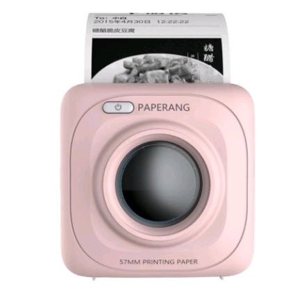 Pink Paperang portable thermal printer printing black and white photo on 57mm paper