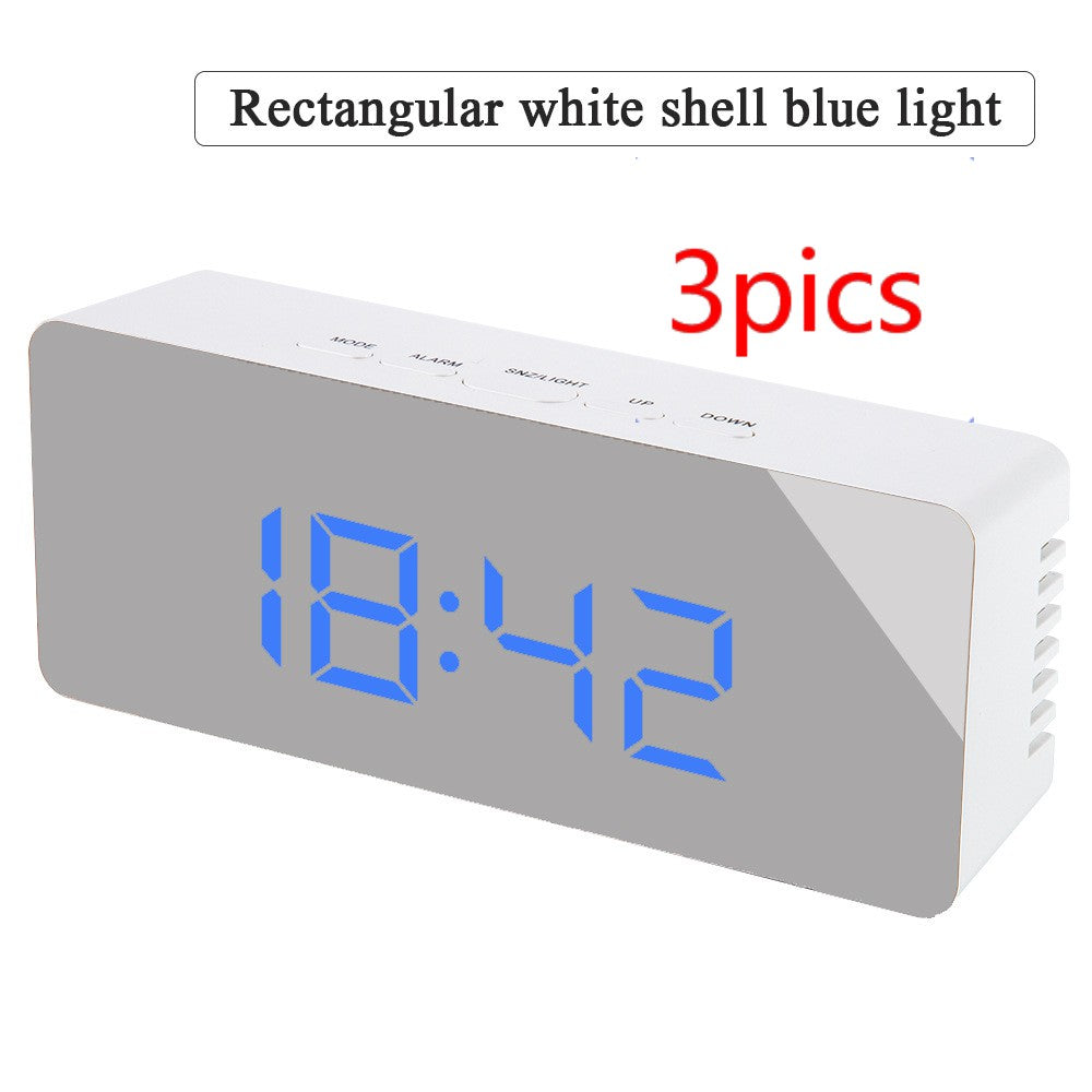 Rectangular white digital alarm clock with blue LED time display 18:42 and control buttons