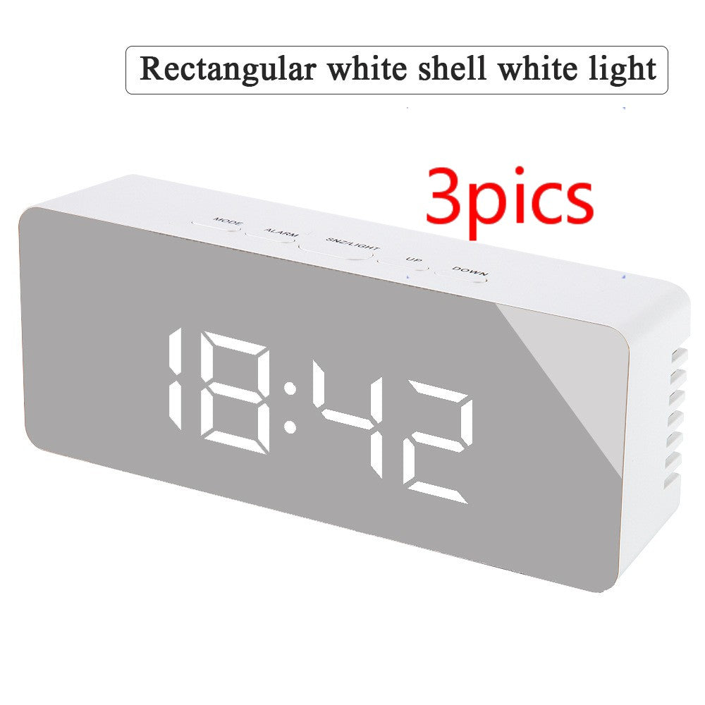 Rectangular digital LED alarm clock with white shell and mirrored front display showing 18:42