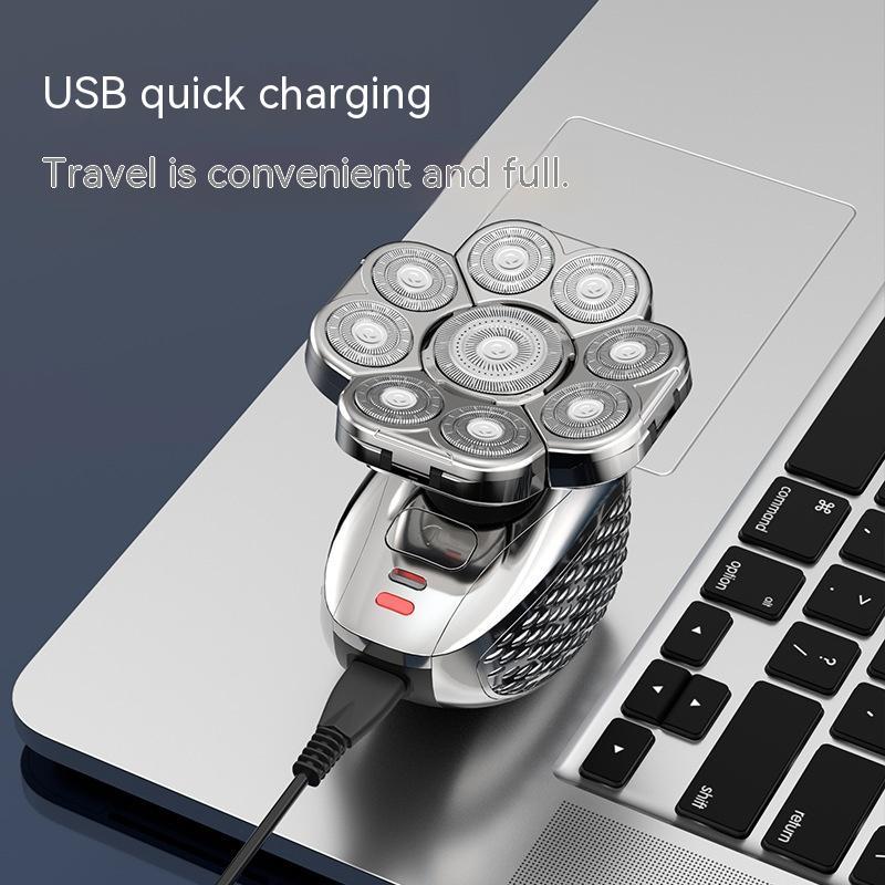 Rechargeable electric shaver with seven rotary blades connected to laptop via USB quick charging cable