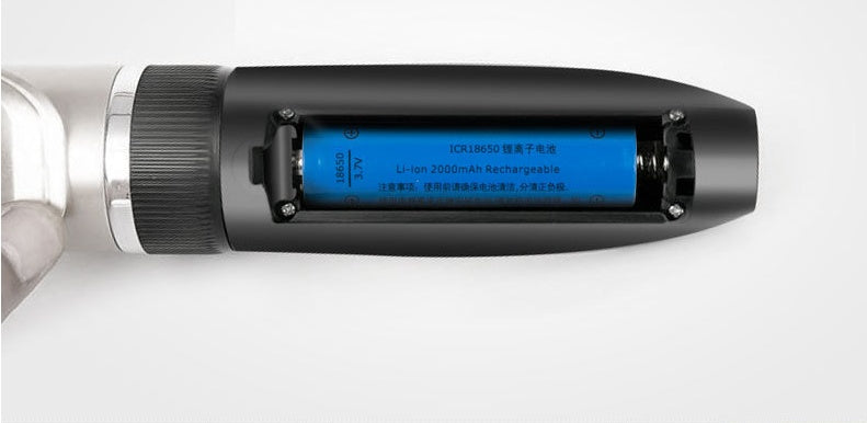 Close-up of rechargeable lithium-ion battery inside a black grooming trimmer handle