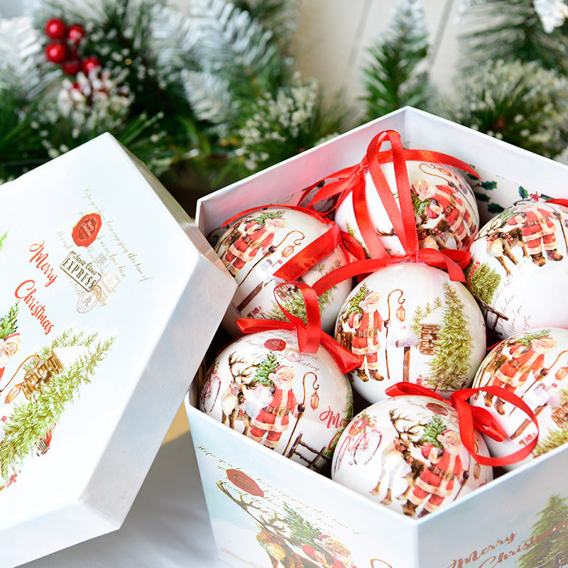Christmas gift box with vintage Santa Claus ornament balls featuring red ribbons and holiday greenery