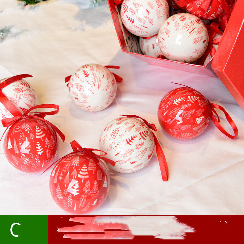 Red and white Christmas tree ornament balls with tree patterns and red ribbons, some inside a red gift box