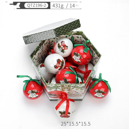 Christmas gift box filled with red and white decorative tree ornaments featuring vintage car designs with green and red ribbons