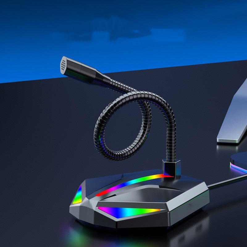 Compact USB gaming microphone with flexible gooseneck and RGB lighting on black desk