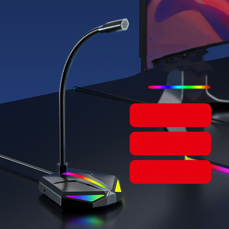 USB gaming microphone with flexible neck and RGB lighting on a black desk next to a monitor