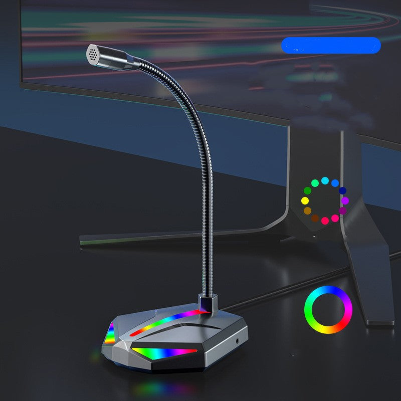 USB gaming microphone with flexible gooseneck and RGB lighting on desktop beside curved monitor