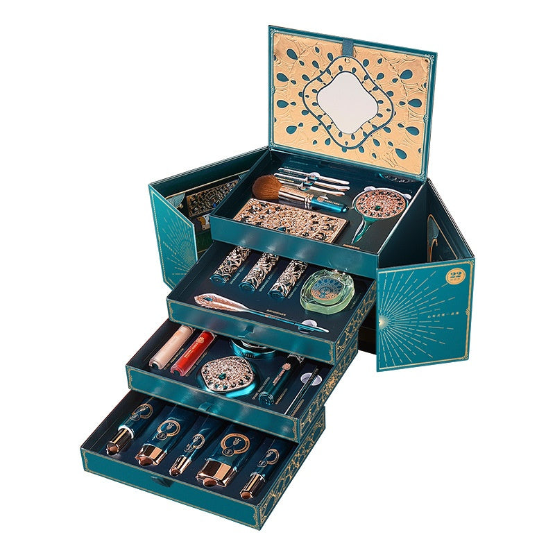 22-piece oriental makeup set in teal and gold box with brushes, lipsticks, and compact mirror