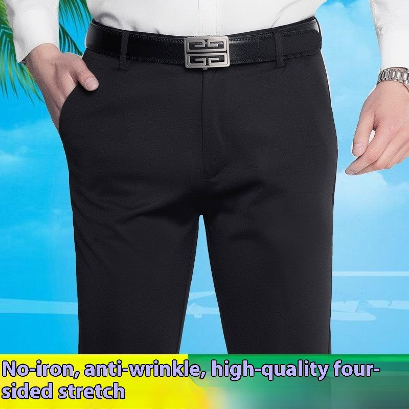 Men's black business casual stretch pants with a silver buckle belt and white shirt against blue sky