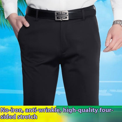 Men's black business casual stretch pants with a silver buckle belt and white shirt against blue sky