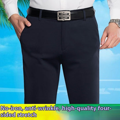 Men's black stretch business casual pants with straight fit and black belt, worn with white shirt