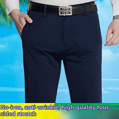 Close-up of men's navy blue business casual stretch pants with black belt against a blue sky background