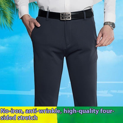 Men's black stretch office pants with straight fit, black belt, and white shirt against blue sky
