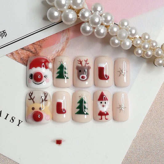 Christmas-themed press on nails with designs of Santa, reindeer, Christmas tree, stocking, and snowflakes