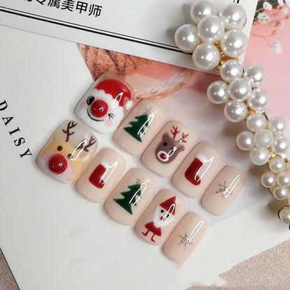 Christmas-themed press-on nails with Santa, reindeer, Christmas trees, stockings, and glitter accents