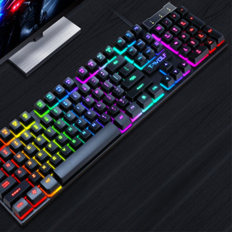 Black wired gaming keyboard with rainbow RGB backlit floating keys on dark desk
