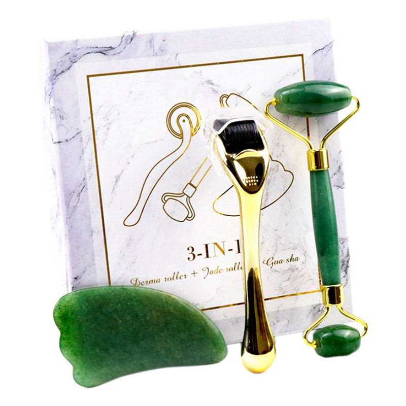 3-in-1 skincare set with gold derma roller, green jade roller, and gua sha stone on marble box