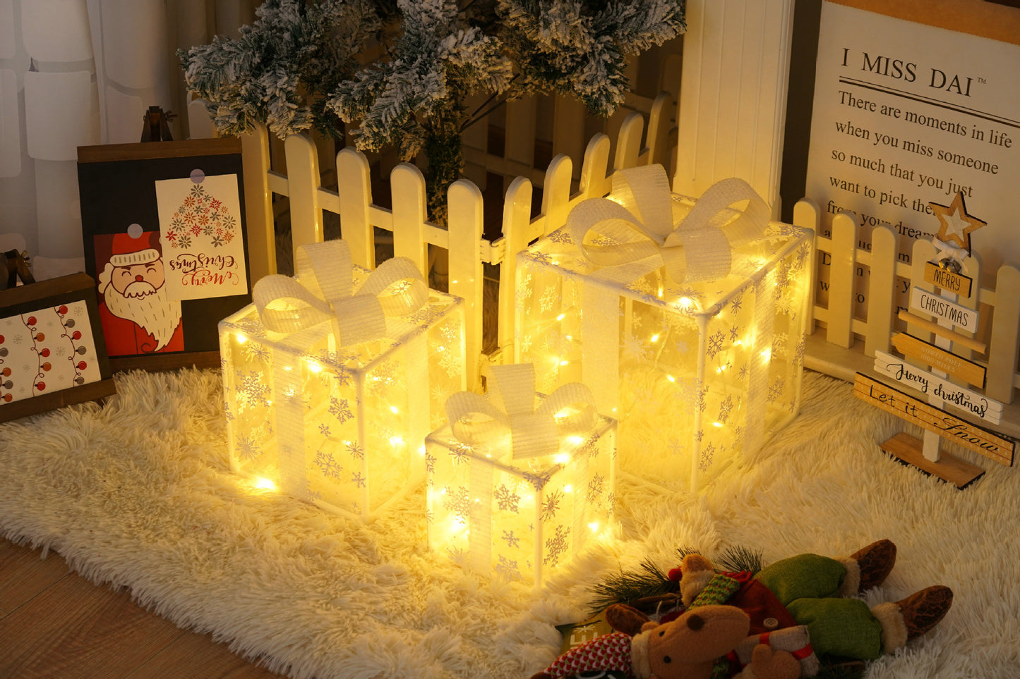 Three glowing Christmas gift boxes with snowflake patterns and white bows on a fluffy rug near a decorated tree