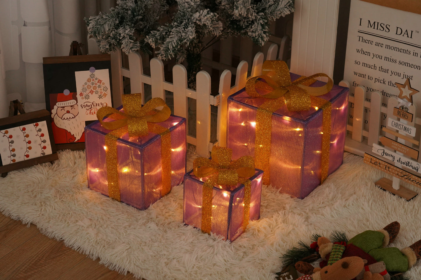 Three glowing purple Christmas gift boxes with golden ribbons on a white rug near festive holiday decor