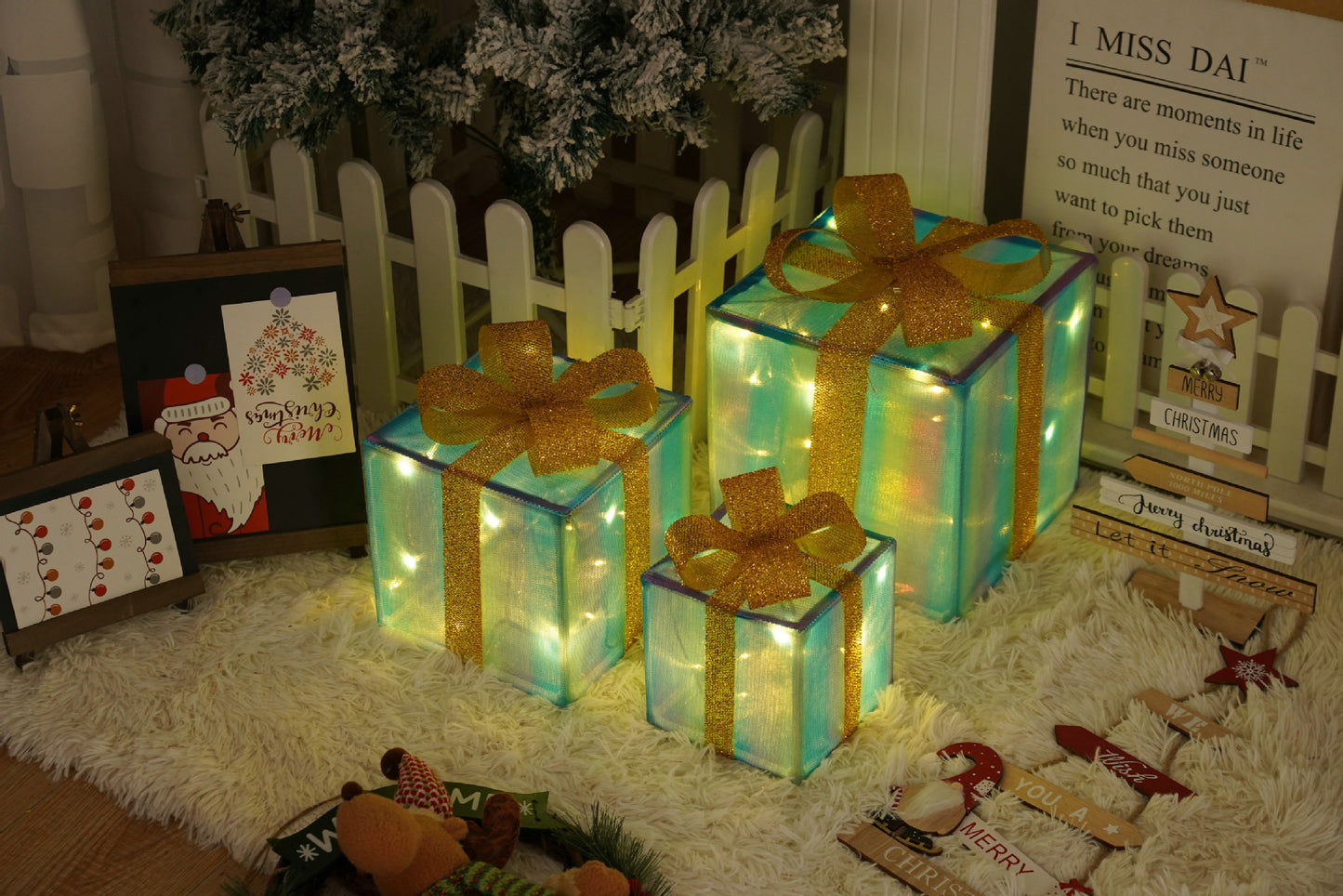 Three glowing Christmas gift boxes with golden ribbons under decorated tree on white rug