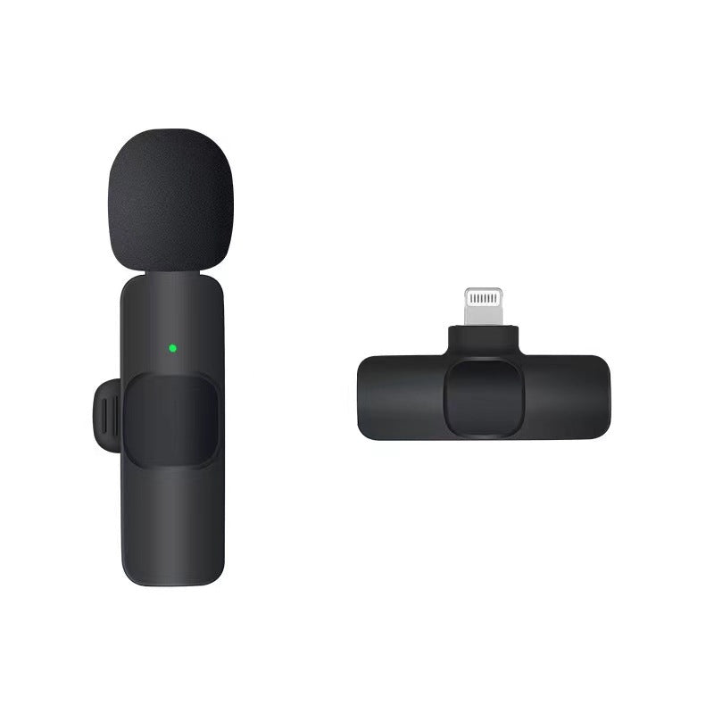 Black wireless lavalier microphone with foam windscreen and Type-C charging adapter on white background