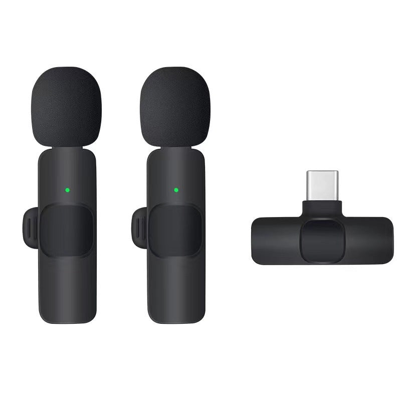 Pair of black wireless lavalier microphones with foam windscreens and USB Type-C receiver adapter