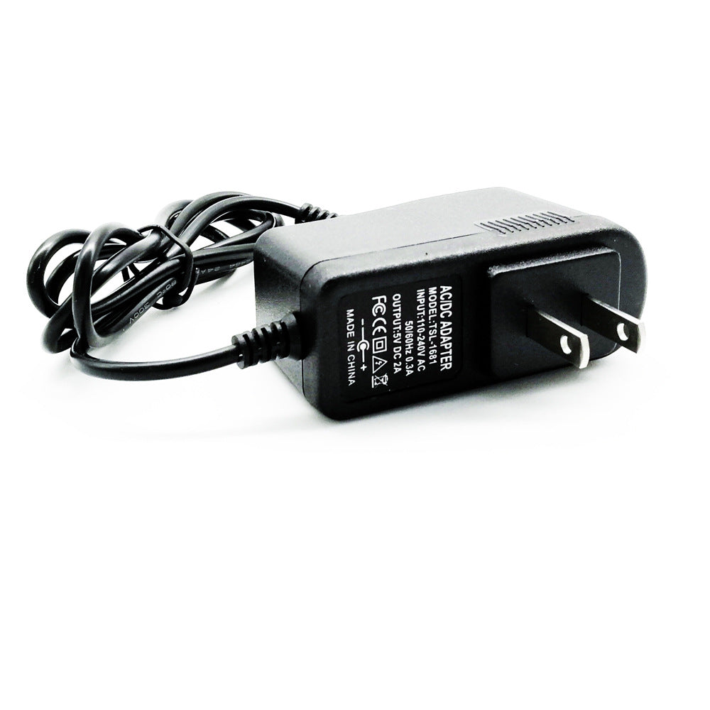 Black AC/DC power adapter with US plug and coiled cable on white background