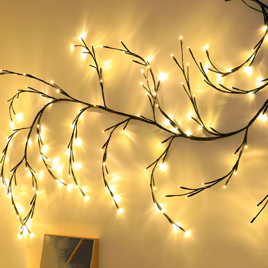 Warm white LED branch string lights hung on wall creating cozy ambient lighting