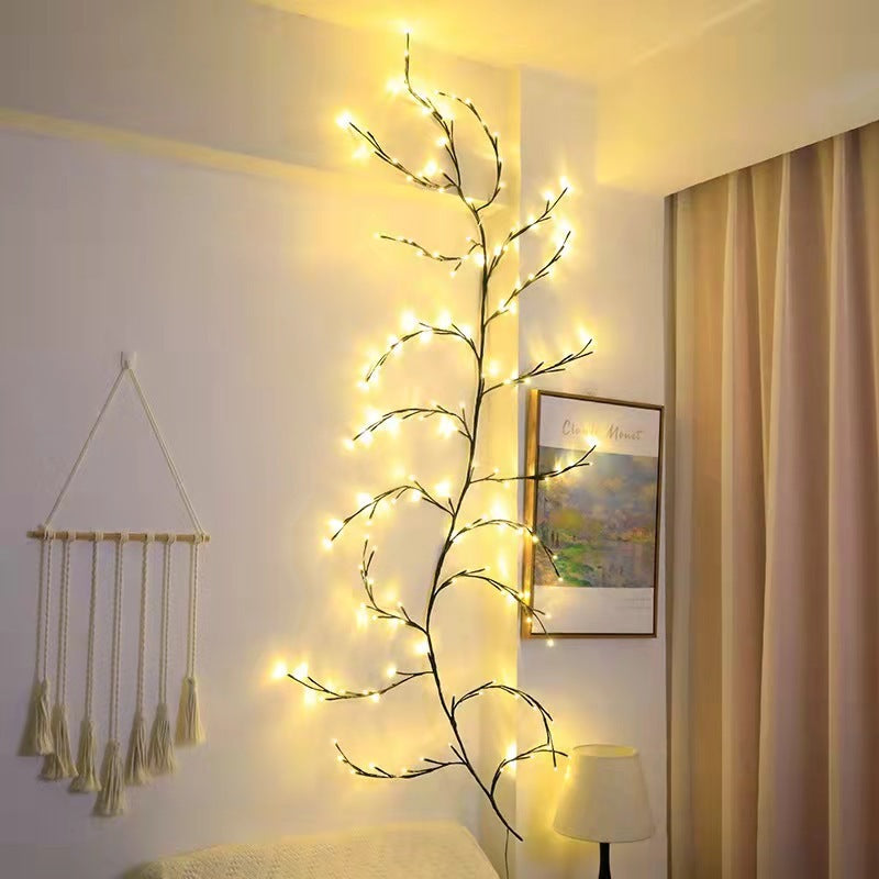 Warm white LED birch vine string lights mounted on wall above bed in cozy bedroom with macrame and curtains