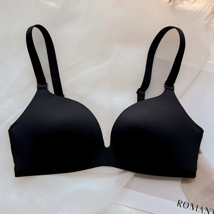Black wireless push-up bra with thin cups and adjustable straps on white fabric background