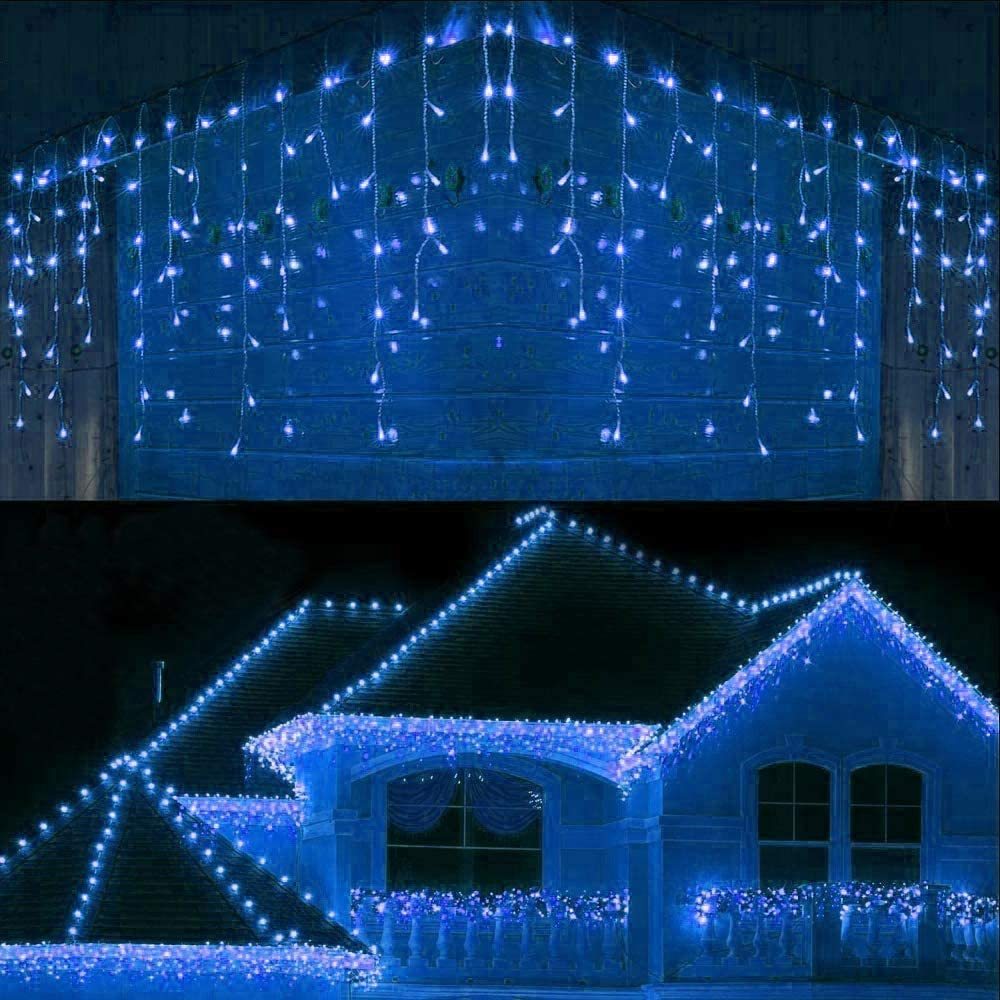Cool white LED icicle Christmas lights decorating house roof edges and balcony railing at night