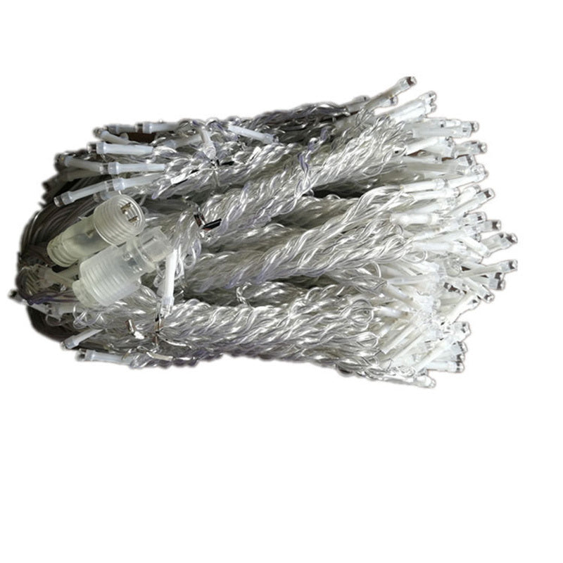 Coiled warm white LED icicle string lights with transparent wires and connectors on white background