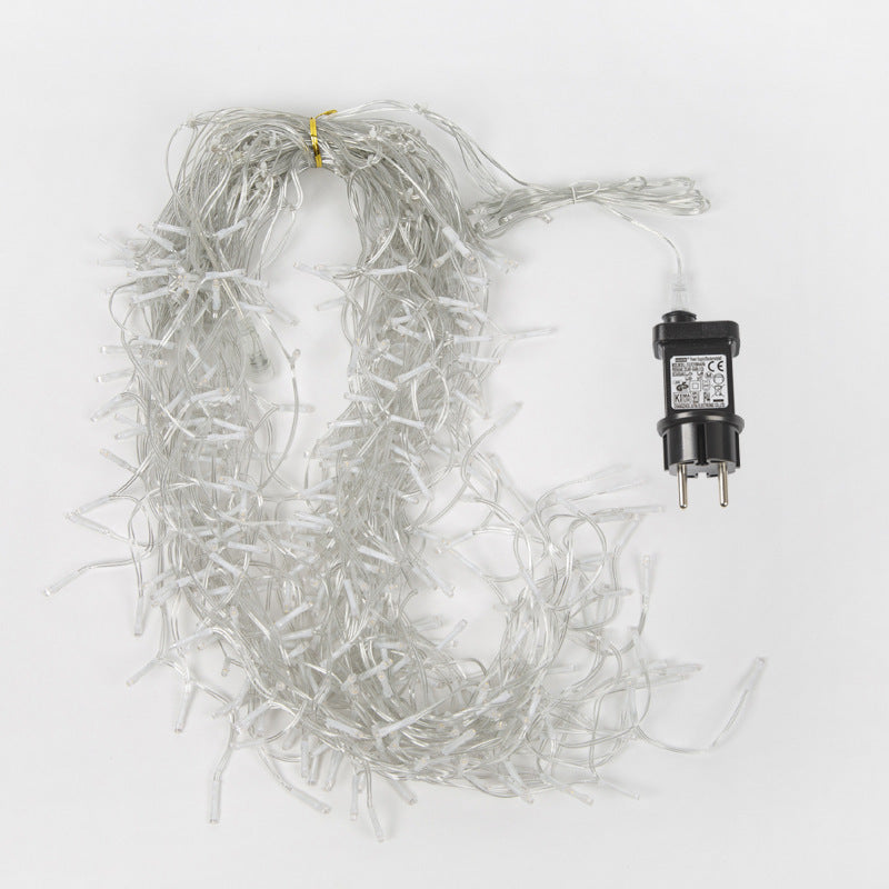 Warm white LED icicle string lights with clear wiring and European plug on white background
