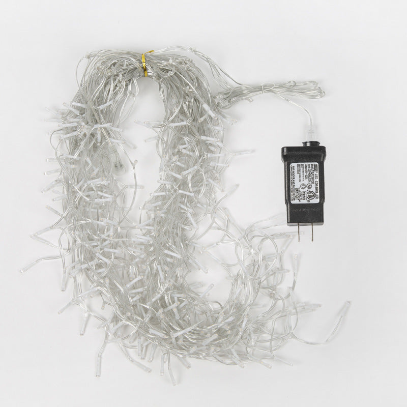 Warm white LED icicle string lights with clear wiring and black AC power adapter on white background