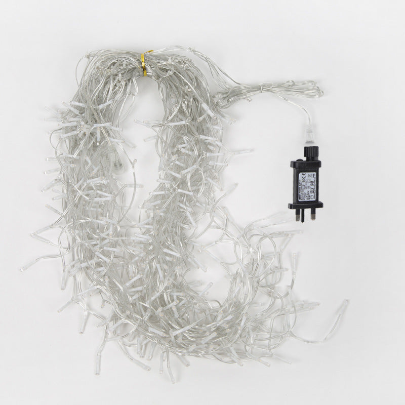 Warm white LED icicle Christmas string lights with clear wires and black plug against white background