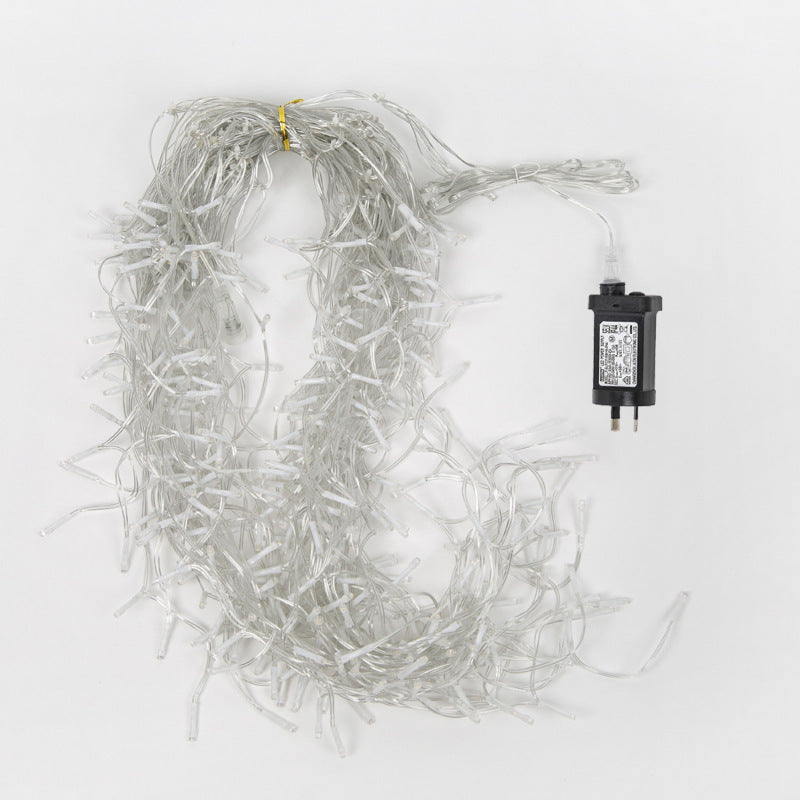 Warm white LED icicle string lights with transparent wires and European plug on white background