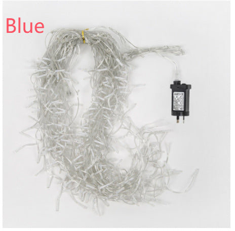 Coiled clear string icicle Christmas lights with an electric plug on white background