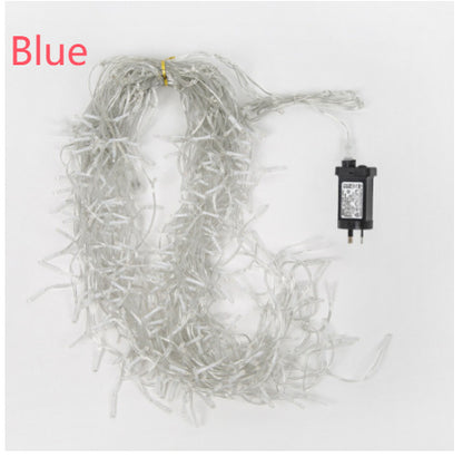 Coiled clear string icicle Christmas lights with an electric plug on white background