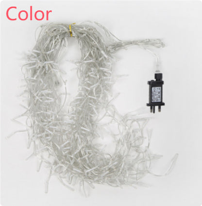 Coiled warm white LED icicle string lights with plug on white background