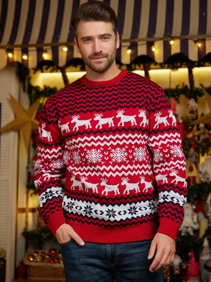Man wearing red Christmas sweater with white reindeer and snowflake patterns in festive decorated room